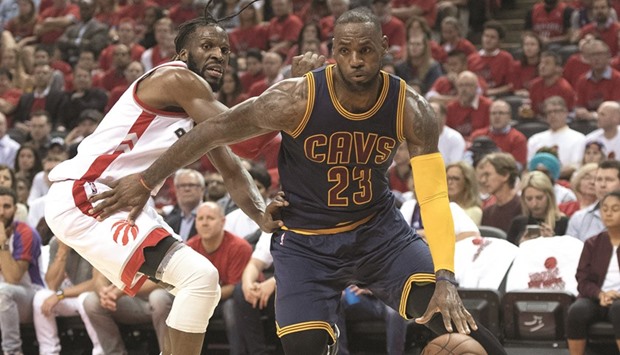 Cleveland Cavaliers forward LeBron James (right) drives to the basket as his Toronto Raptors counterpart DeMarre Carroll tries to defend during the third quarter in Game 6 of the Eastern Conference finals of the NBA Playoffs on Friday. Cavs won 113-87 to seal the best-of-seven series 4-2. (Nick Turchiaro-USA TODAY Sports)