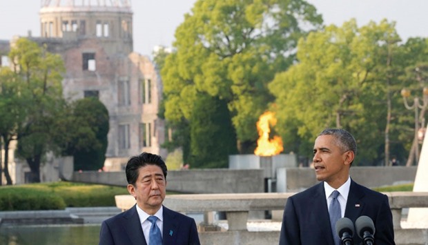 US President Barack Obama, accompanied by Japanese Prime Minister Shinzo Abe, delivering a speech after laying a wreath to a cenotaph at Hiroshima Peace Memorial Park in Hiroshima on Friday.