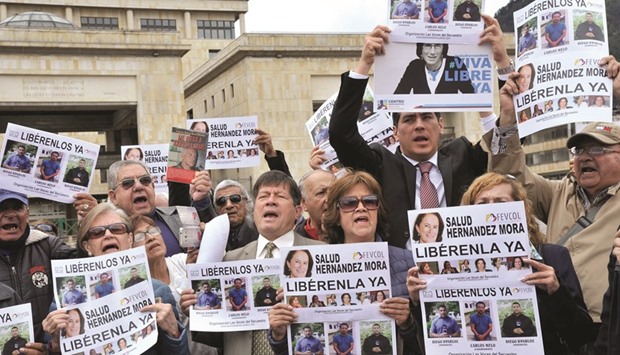 People demonstrate in Bogota early on Friday, seeking the release of Spanish-Colombian journalist Salud Hernandez-Mora.