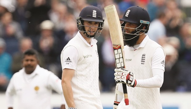 Englandu2019s Moeen Ali (left) celebrates his century as Chris Woakes looks on during the second Test against Sri Lanka at the Riverside in Chester Le Street, north east England yesterday (AFP)