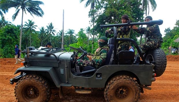 Moro National Liberation Front (MNLF) fighters riding in a jeep while escorting members of the media to their mountain lair in Indanan town, Jolo province, in southern island of Mindanao. Philippine president-elect Rodrigo Duterte has said he will visit Jolo to talk to MNLF chiarman Nur Misuari.