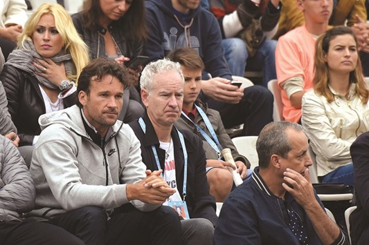 Former US tennis player John McEnroe (second from left) attends the menu2019s fourth round French Open  in Paris yesterday. (AFP)