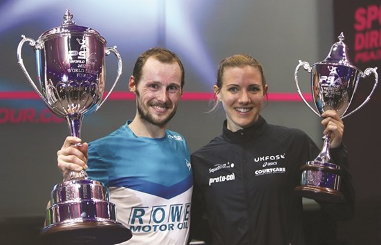 Gregory Gaultier of France and Laura Massaro of Great Britian pose with their trophies after winning the menu2019s and womenu2019s finals of the PSA World Series Finals squash tournament in Dubai on Saturday.
