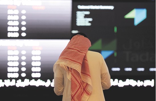 A Saudi investor monitors stock prices at the Saudi Stock Exchange, or Tadawul, in the capital Riyadh (file). Saudi Arabiau2019s stock exchange, the biggest in the Middle East and Africa, has hired HSBC Saudi Arabia Ltd as a financial adviser for its initial public offering, scheduled for 2018.