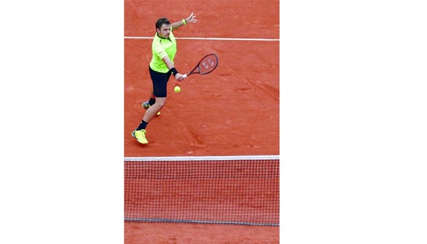 Stan Wawrinka of Switzerland in action against Serbiau2019s Viktor Troicki during their French Open match at Roland Garros in Paris yesterday. (Reuters)