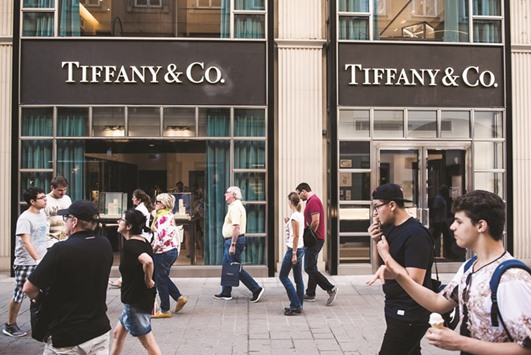 Pedestrians walk past the entrance to a Tiffany & Co jewellery store in Vienna. US jeweller Tiffany recently announced a disappointing financial forecast, and the maker of the well-known British Burberry trench coat has embarked on a money-saving plan.