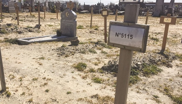 This photo taken on April 19 shows graves of migrants at a cemetery in Calais. In the northern cemetery of Calais, migrantsu2019 graves are easily identifiable in the middle of the Muslim section: a simple wooden cross, engraved with a name accompanied most often only by the date of death. When the identification is not possible, they are buried in an isolated area of the cemetery.