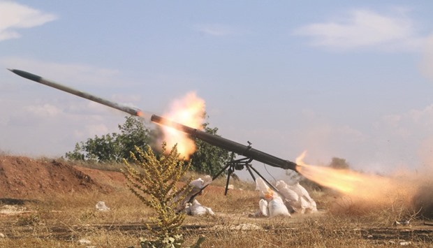 Rebel fighters from the First Regiment, part of the Free Syrian Army, fire a Grad rocket from Aleppou2019s Al-Haidariya neighbourhood, towards forces loyal to Syriau2019s President Bashar al-Assad stationed in Talet al-Sheikh Youssef, Syria, yesterday.