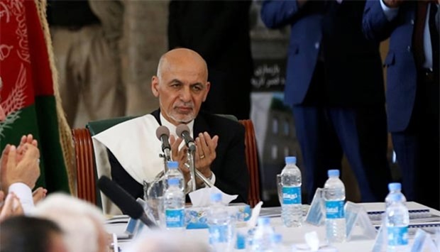 President Ashraf Ghani prays during the inauguration of the reconstruction project to restore the ruins of Darul Aman palace in Kabul on Monday.