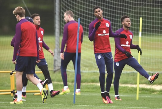 Englandu2019s striker Marcus Rashford (second right) takes part in a team training session in Watford, north of London, yesterday. (AFP)