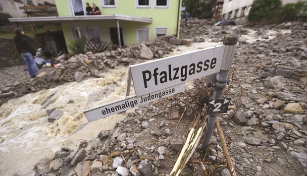 Rubble is seen yesterday in a flooded street in Braunsbach, southern Germany. Four people died and several more were injured after violent storms with torrential rains caused severe flooding, authorities said.