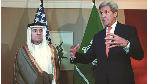 US Secretary of State John Kerry gestures next to Saudi Foreign Minister Adel al-Jubeir during a meeting on Syria in Geneva yesterday.