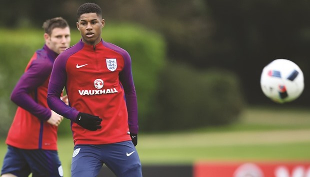 File picture of Englandu2019s striker Marcus Rashford (2nd L) taking part in a team training session in Watford, north of London.