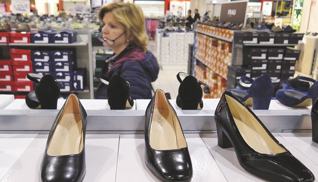 A woman looks for shoes in a shop in Rome. Euro-area consumer prices fell 0.1% in May from a year earlier, the European Unionu2019s statistics office in Luxembourg said yesterday.
