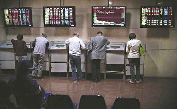 Investors follow financial information at a securities brokerage in Shanghai. The rout in the Shanghai Composite Index, which has lost more than a third of its value since the end of April 2015, followed one of the benchmarku2019s best rallies ever and shocked global markets as indicated by how badly the analysts covering Chinese equities performed.