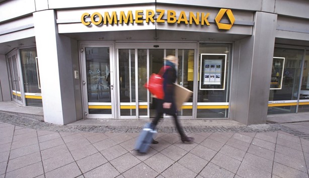 A pedestrian walks past a branch of Commerzbank in Frankfurt. The banku2019s shares plunged 9.6% to u20ac7.32 yesterday.