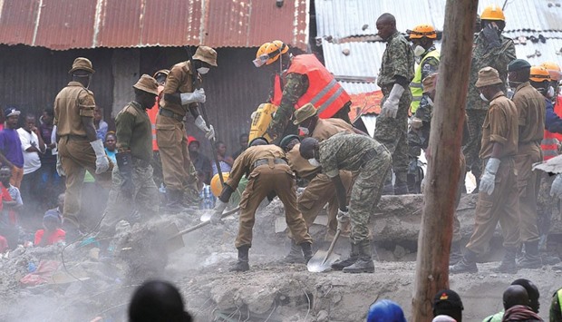 Rescue workers remove debris from the rubble of the six-storey building that collapsed in Nairobiu2019s suburb of Huruma.