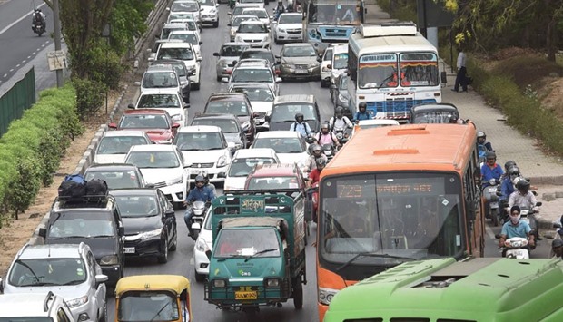 Commuters travel in a traffic jam on their way to Gurgaon from New Delhi yesterday. The national capital witnessed massive jams for a second day as taxi drivers protested against the ban on diesel cabs.