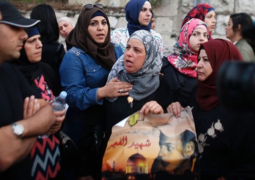 Suha (centre), the mother of killed Palestinian teenager Mohamed Abu Khdeir, takes part in a protest outside the district court in Jerusalem yesterday after a life sentence was handed down to the ringleader of a Jewish gang who kidnapped, beat and burned alive her son in 2014.