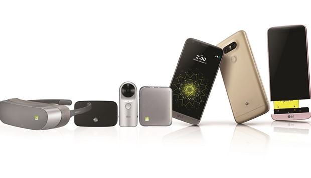 The LG G5 smartphone with some companion devices.