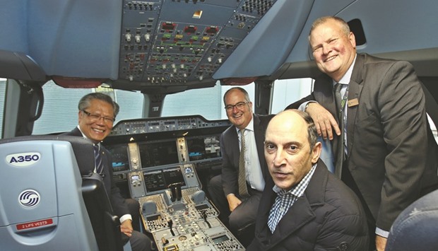 Akbar al-Baker welcomes the VIP delegation, comprising Hieu Van Le, Leon Bignell and Mark Young, to the flight deck of Australiau2019s first A350 aircraft.