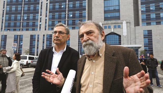 Belge (right) and Nobel laureate Pamuk leave Kartal Justice Palace in Istanbul after Belge appeared in court on charges of insulting Erdogan.