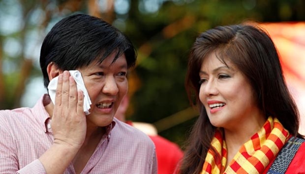 Bongbong Marcos talks to his sister Imee Marcos during the announcement of his candidacy in Manila in October last year.