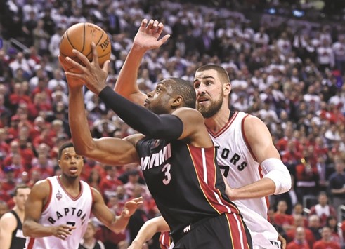 Miami Heat guard Dwyane Wade (No 3) shoots past Toronto Raptors guard Jonas Valanciunas (R) in game one of the second round of the NBA Playoffs at Air Canada Centre. PICTURE: USA TODAY Sports