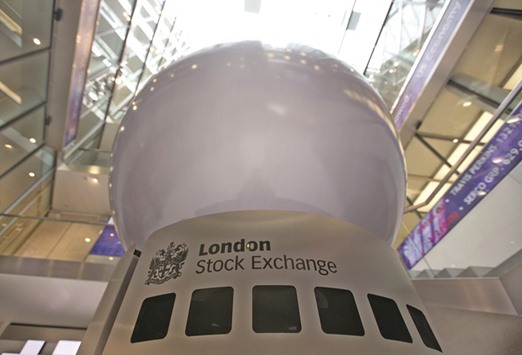 A logo is displayed on an interactive sculpture in the main atrium of the London Stock Exchange headquarters. The FTSE 100 closed down 1.2% to 6,112.02 points yesterday.