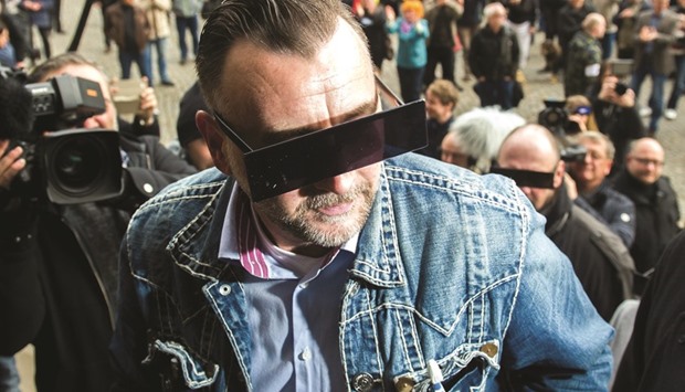 Pegida founder Bachmann has his eyes covered as if pixelised by media as he arrives for his trial on April 19 in Dresden.