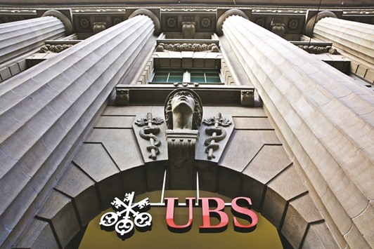 A sign hangs above the entrance to UBS headquarters in Zurich. From UBS Groupu2019s wealth-management unit to Commerzbanku2019s consumer-lending business, income is shrinking as margins get squeezed and clients avoid trading.