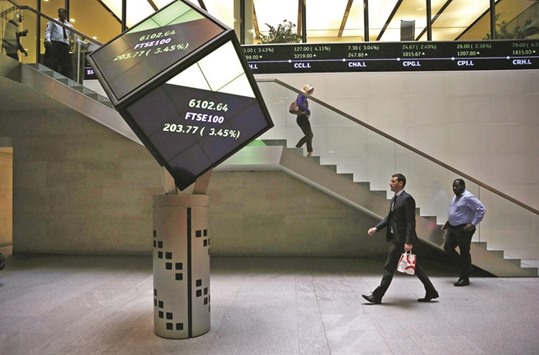 People walk through the lobby of the London Stock Exchange. US exchange and clearing house operator Intercontinental Exchange said yesterday it did not intend to make a rival offer for London Stock Exchange Group, which has agreed to merge with German peer Deutsche Boerse.