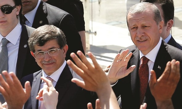Turkeyu2019s then-Prime Minister Tayyip Erdogan (right) and then-Foreign Minister Ahmet Davutoglu greet their supporters as they leave Friday prayers in Ankara in this photo taken on August 22, 2014. Rising tension between the countryu2019s two leaders is undermining confidence in the $720bn economy.