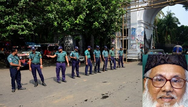 Bangladeshi police officials stand guard in Dhaka on Thursday. Inset, Motiur Rahman Nizami