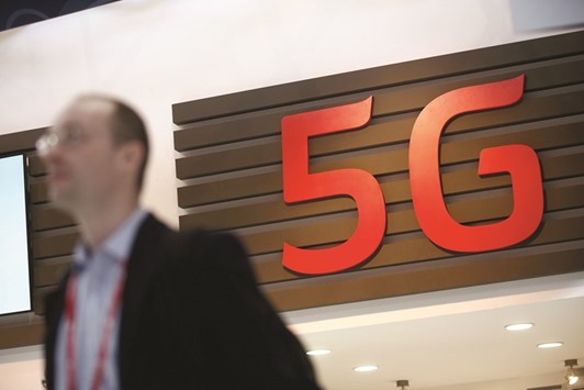 A 5G sign sits on display in a hallway at the Mobile World Congress in Barcelona, Spain, on March 3, 2015. The 5G rollout represents the biggest expansion of the Internet to date and has the potential to generate billions of dollars of business for the likes of Cisco Systems, Nokia, Ericsson, Qualcomm and Intel. All are vying to build the nuts and bolts of the new networks; their ability to lasso contracts could determine whether some of these companies survive.