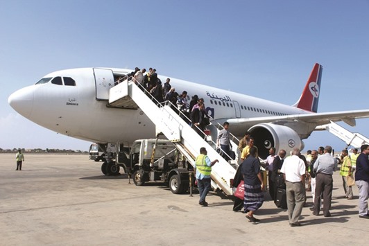 Passengers disembark from a Yemenia aircraft coming in from Jordan yesterday at the International Airport in Aden, the first passenger plane landing after the airport reopened yesterday after months of closure due to security issues.
