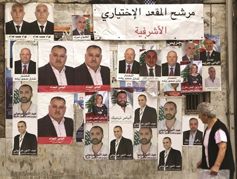 A Lebanese walks past posters of candidates for the upcoming Beirut municipal elections in the Lebanese capitalu2019s Christian dominated neighbourhood of Ashrafiyeh.