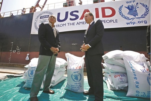 Benjamin Moeling (right), the charge du2019affaires of the US embassy in Khartoum, stands with WFP Sudan chief Adnan Khan as a US aid shipment arrives at Port Sudan on the Red Sea coast.