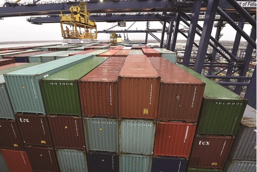 Port workers inspect containers at the CSCL Globe in London. Britainu2019s economic growth may be just 0.1% in the second quarter, down from 0.4% in the first three months of this year, financial data company Markit said yesterday.