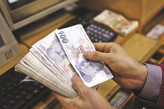 A money changer counts Turkish lira bills at a currency exchange office in central Istanbul. The lira, which hit 2.9765 against the dollar late on Wednesday, stood at 2.9269 by 0524 GMT yesterday. It had been below 2.8 on Monday, its firmest for six months.
