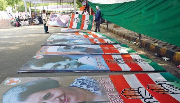 Workers prepare posters of Congress leaders ahead of a u2018save democracyu2019 rally to be held in New Delhi today.