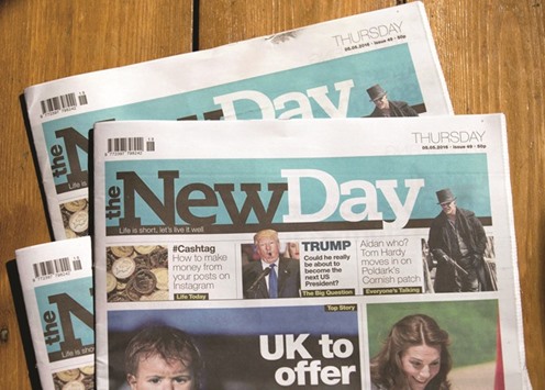 Copies of The New Day newspaper are pictured in south London yesterday.