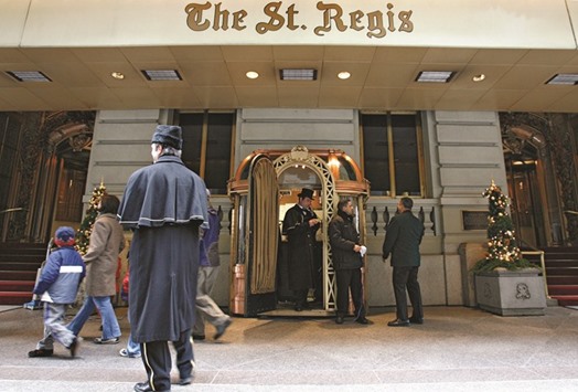 Pedestrians and staff stand outside the St. Regis hotel in New York (file). The St. Regis New York, a Beaux Arts landmark on 55th Street off Fifth Avenue, has 238 rooms.