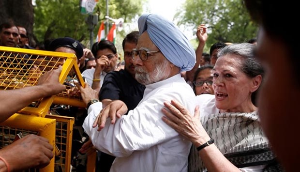 Congress party president Sonia Gandhi and former prime minister Manmohan Singh cross a police barricade during a march to parliament in New Delhi on Friday.