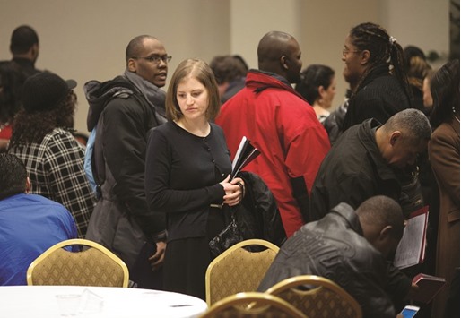 Job seekers talk to recruiters and fill out applications at a job fair in New York. The US economy added the fewest number of jobs in seven months in April and Americans dropped out of the labour force in droves, signs of weakness that cast doubts on whether the Federal Reserve will raise interest rates before the end of the year.