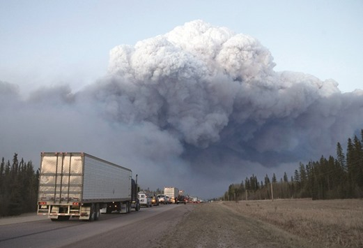 Drivers wait for clearance to take firefighting supplies into town outside of Fort McMurray, Alberta.