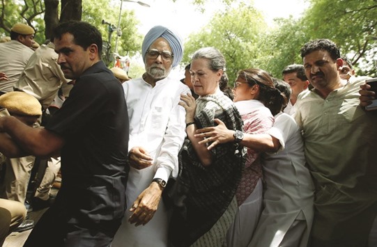 Congress party president Sonia Gandhi and former prime minister Manmohan Singh cross a police barricade during what the party calls as a u201cSave Democracyu201d march to parliament in New Delhi yesterday.