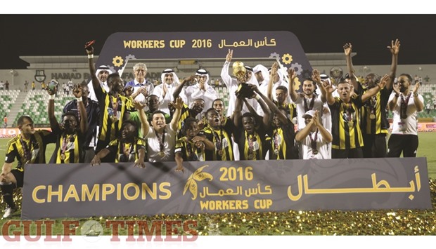 Taleb Group players pose with the trophy as Supreme Committee secretary-general Hassan al-Thawadi and other officials applaud. PICTURE: Othman Iraqi