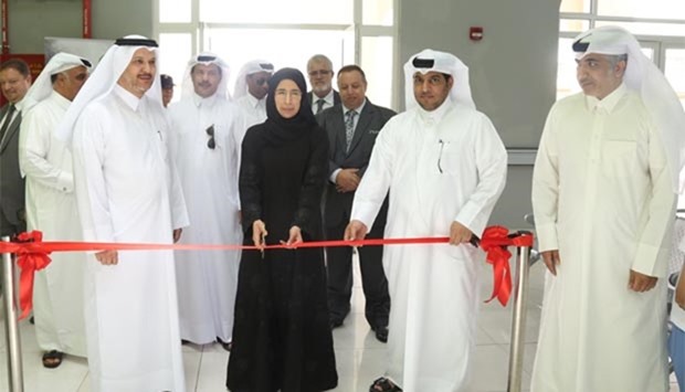 HE Dr. Hanan Mohammad al-Kuwari opens the Mesaimeer Labour Health Centre by cutting a ribbon
