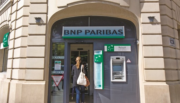 A customer enters a BNP Paribas branch in Paris. Less than two years after BNP Paribas agreed to pay a record $9bn US fine in part for dealings with Iran, many of the continentu2019s biggest banks remain unwilling to go anywhere near Iran-related business for fear that they will run afoul of remaining US sanctions on the country.